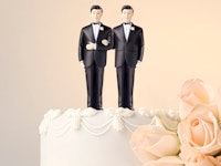 Same-sex wedding cake with two men in formal suits on top