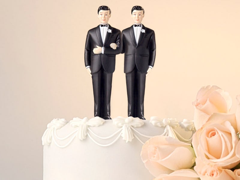 Same-sex wedding cake with two men in formal suits on top