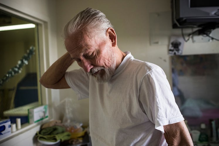 An old man with terminal colon cancer at a hospital