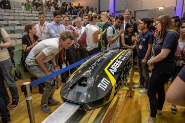 TUM Hyperloop's pod design with people looking at it