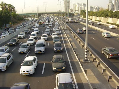 A semi-aerial view of large row with cars with a traffic problem