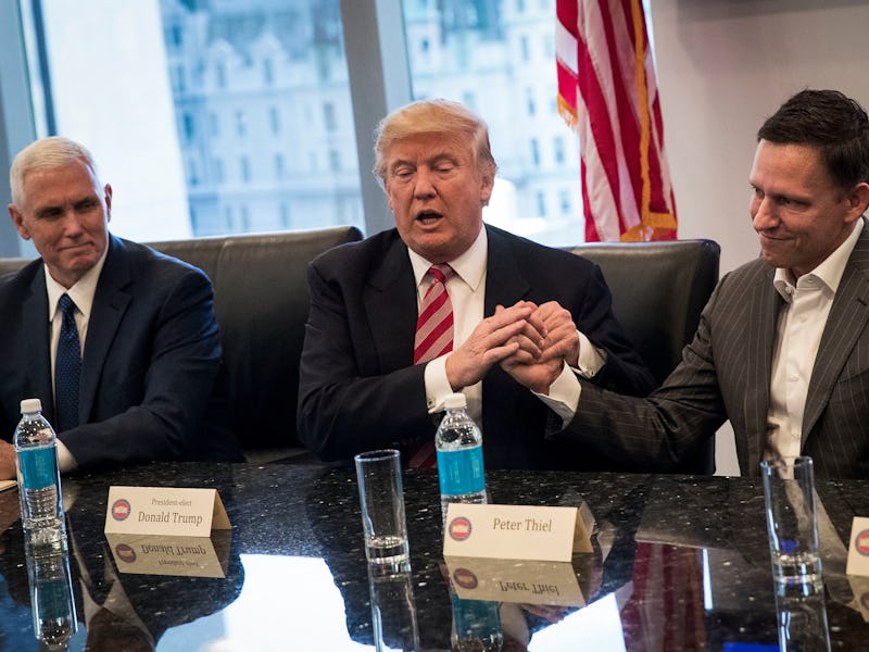 Donald Trump speaking while holding Peter Thiel's hands