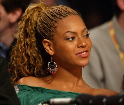Beyoncé wearing blonde micro braids with curly ends.