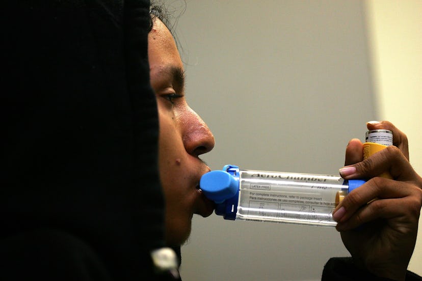 A man in a black hoodie using a new type of asthma inhaler