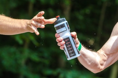 A man passing his bottle of water to his friend