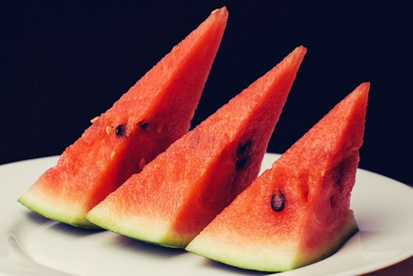 Pieces of cut watermelon stacked in a row