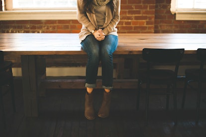 A girl with ADHD sitting on a table