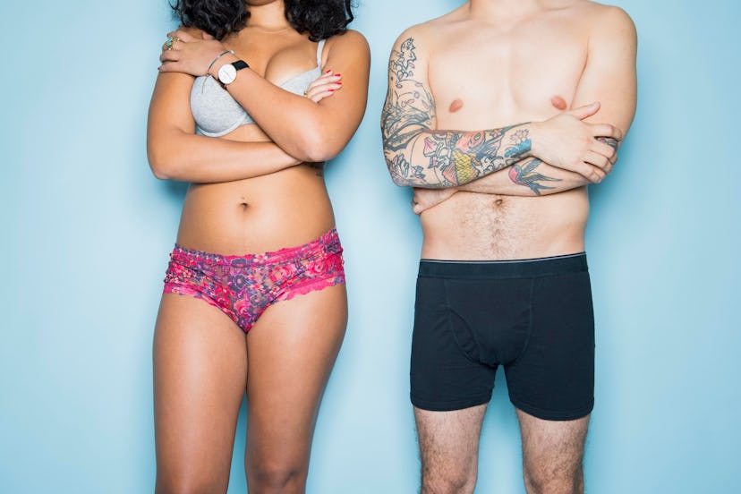 Young couple in their underwear, standing uncomfortably