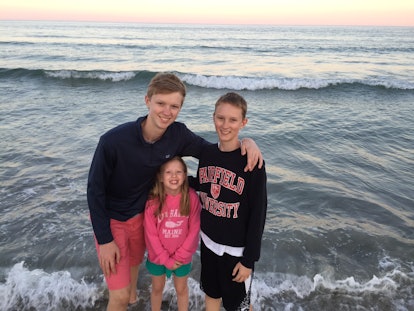 A woman who has PCOS with her two children at the beach
