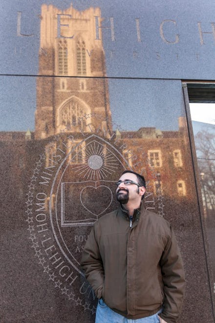 Matt Rozsa posing next to a library