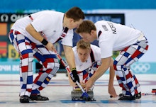 Norwegian Men's Curling team on the rink, wearing checkered pants that may be against the IOC rules 