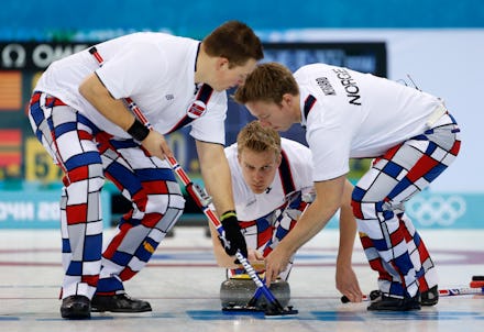 Norwegian Men's Curling team on the rink, wearing checkered pants that may be against the IOC rules