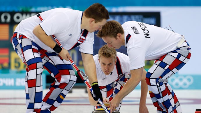 Norwegian Men's Curling team on the rink, wearing checkered pants that may be against the IOC rules 