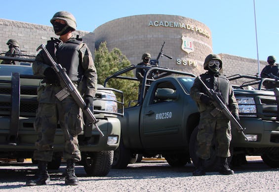 Armed Mexican police standing in front the police academy due to violence between drug cartels and l...