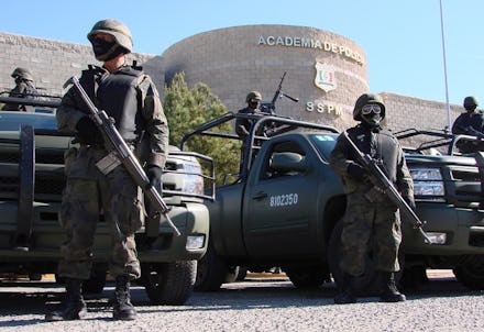Armed Mexican police standing in front the police academy due to violence between drug cartels and l...
