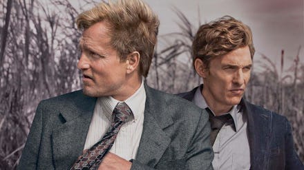 Woody Harrelson and matthew McConaughey standing in suits on the poster for true detective