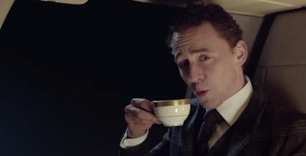 Tom Hiddleston in a suit holding a cup of tea in a super bowl ad