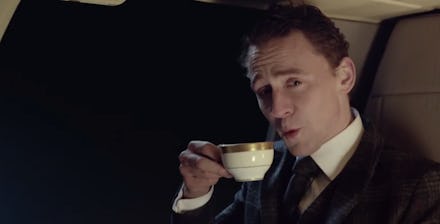 Tom Hiddleston in a suit holding a cup of tea in a super bowl ad
