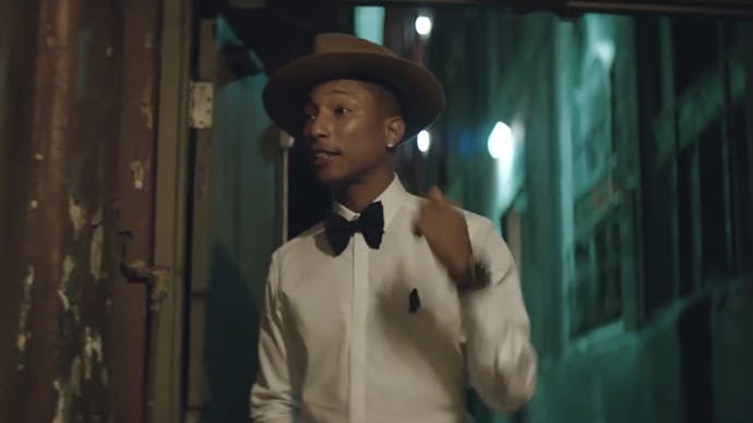 Pharrell Williams in a white shirt, black bow tie and grey hat