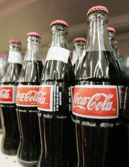 Coca-Cola glass bottles displayed on a shelf