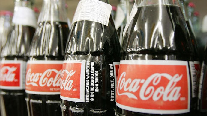 Coca-Cola glass bottles displayed on a shelf