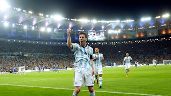 Messi celebrating after scoring a goal at the 2014 World Cup 
