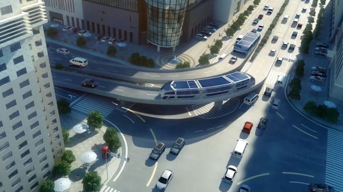 A futuristic bus that lets cars drive through it from an aerial view