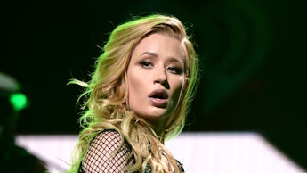 Iggy Azalea performing live in a green top and green pants