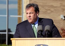 Chris Christie delivering a  speech in a striped suite and green tie