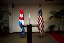 Flags of the United States and Cuba and a microphone platform