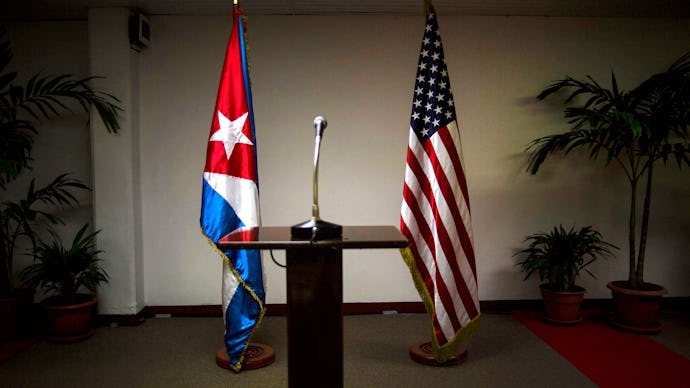 Flags of the United States and Cuba and a microphone platform