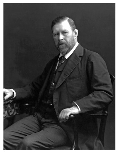 Black and white photograph of Bram Stoker sitting in the chair
