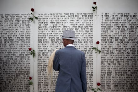 A Black Jew praying in front of a wall