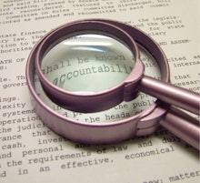 A smaller magnifier on top of a bigger one pointing out the word 'accountability' in a paragraph