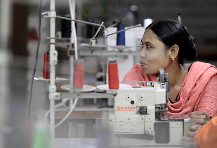 A woman sitting in the tailoring studio