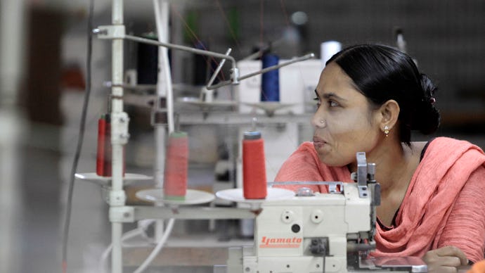 A woman sitting in the tailoring studio