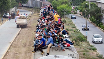 A group of immigrants on the roof of a moving train