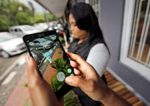 People playing 'Pokémon Go' in front of their home