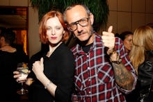 Terry Richardson with a ginger woman who is holding a drink in her hand