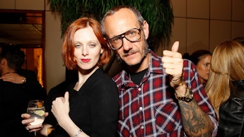 Terry Richardson with a ginger woman who is holding a drink in her hand