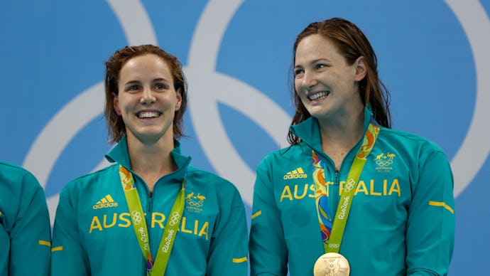 Cate and Bronte Campbell, Sisters and Olympic Swimmers posing together and smiling with their medals
