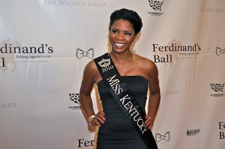 Former Miss Kentucky winner Djuan Keila Trent, in a strapless black dress and her "Miss Kentucky" sa...