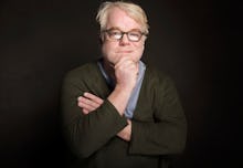 Philip Seymour Hoffman posing for a photo in a black blazer