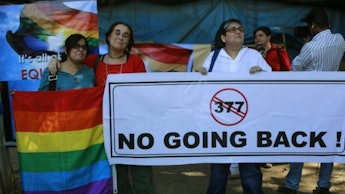 A group of people protesting India's Ban on gay sex with a large poster 'NO GOING BACK'