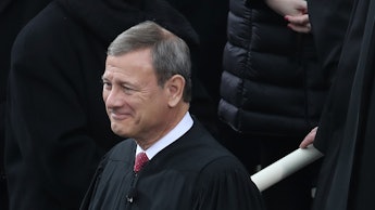 Chief Justice John Roberts standing and smiling