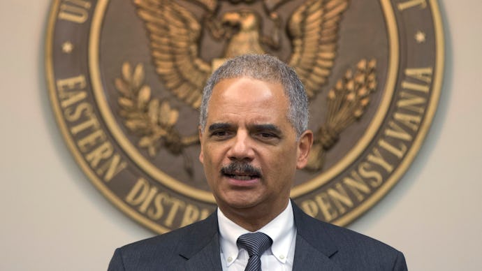 Eric Holder in a suit and tie with the Eastern District Pennsylvania emblem behind him