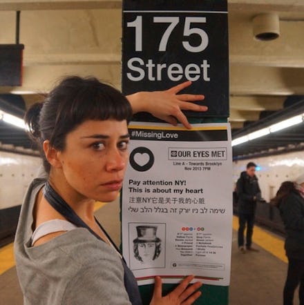 A new york artist posting a #missinglove sign on a subway pole