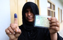 An Afghan woman showing her inked finger after voting in Jalalabad. 