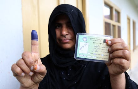 An Afghan woman showing her inked finger after voting in Jalalabad.