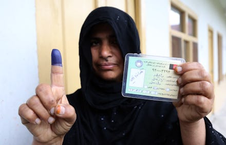 An Afghan woman showing her inked finger after voting in Jalalabad. 